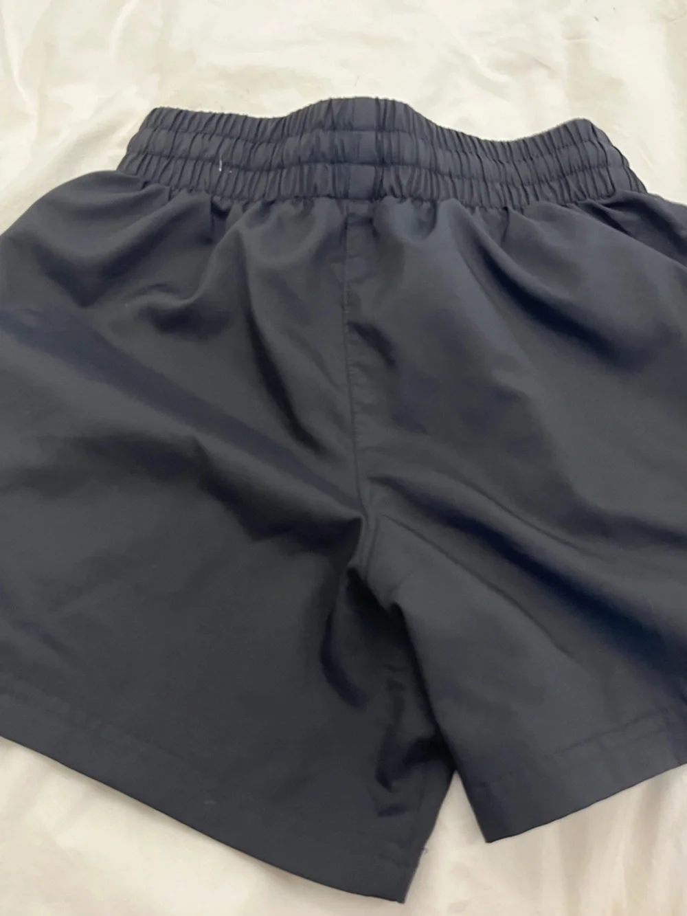 Nike kids Black Athletic Shorts with White Swoosh